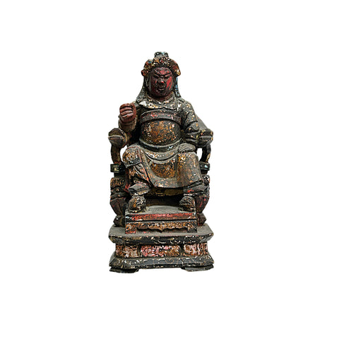 Statue of a seated figure with armor on