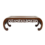 Decorative wooden table with intricate carvings on a white background