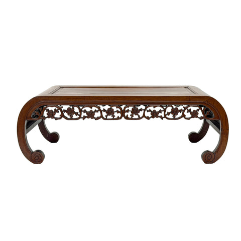 Decorative wooden table with intricate carvings on a white background