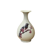 white ceramic bird vase