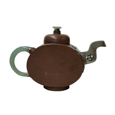 Brown ceramic teapot with green handle on a white background