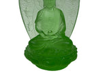 A translucent green glass Buddha statue seated on a lotus base, with a matching green decorative halo or shield behind it, shown against a plain white background.