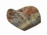 A carved stone sculpture depicting a landscape scene with trees and a deer, made from marbled stone in beige, brown, and reddish tones, isolated on a white background.