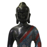 metal Buddha statue on lotus base